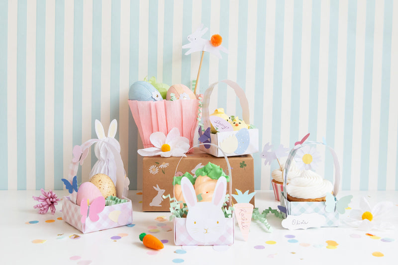 Pink and blue gingham, square baskets hold sweet treats such as cupcakes.