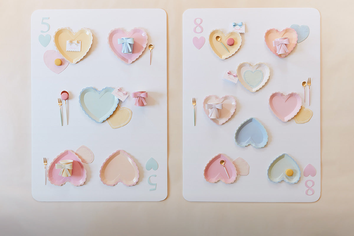 Two cards, the 5 and 8 of hearts, are created out of pastel heart plates in colors of yellow, green, pink, and blue.