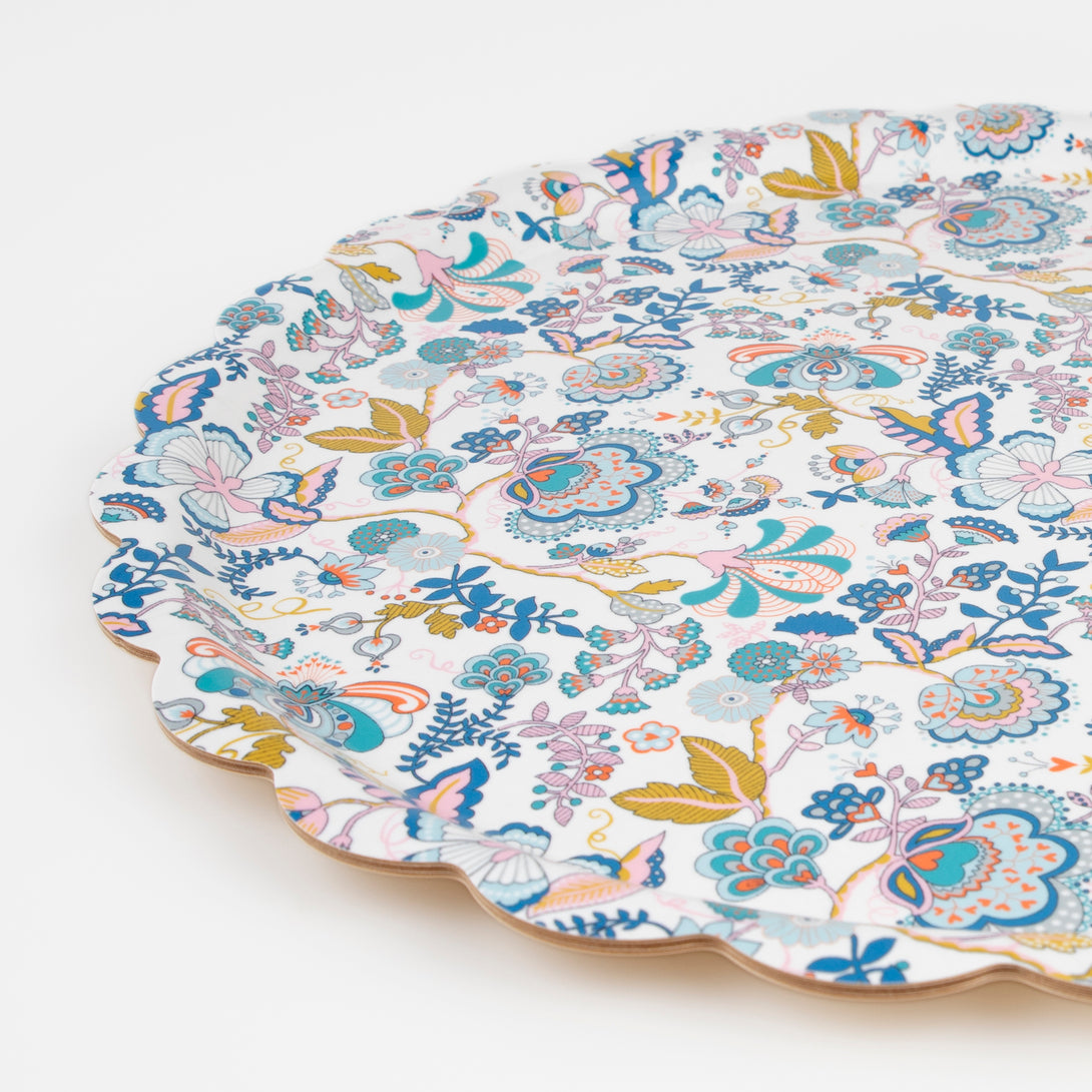 Our wooden round tray has a scalloped edge, floral Liberty print design, and a melamine finish.