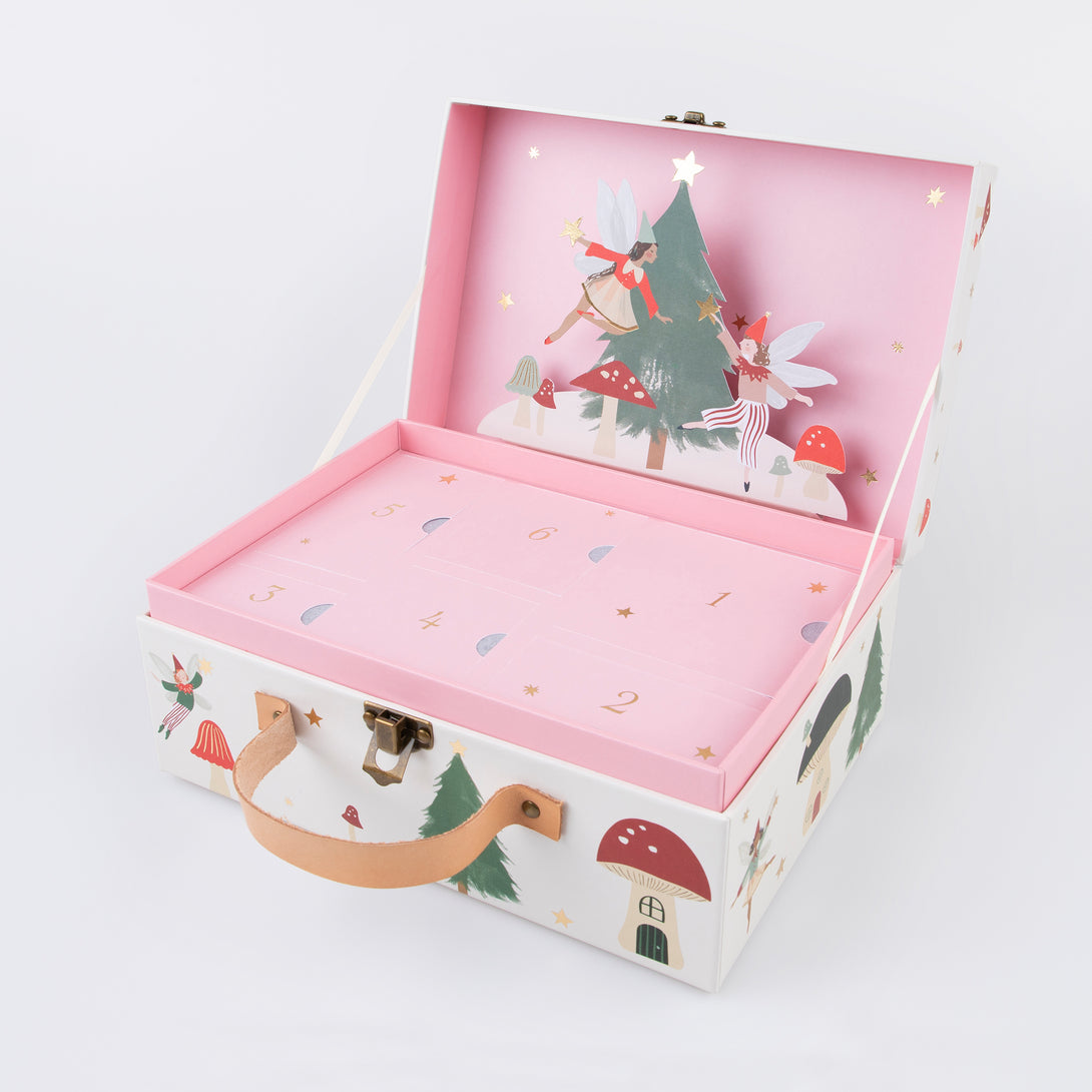 Our wooden advent calendar contains a woodland scene complete with paper fairies, presented in a suitcase, a fun interactive gift