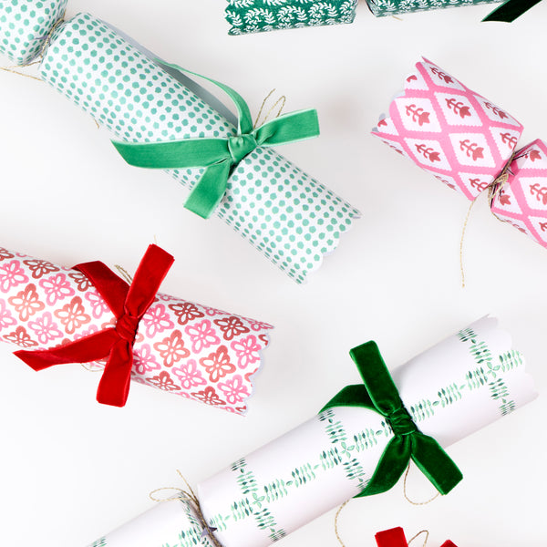 Our luxury Christmas crackers feature Molly Mahon block print designs in seasonal colours and velvet bows, with a hat, joke and special gift inside. Image4