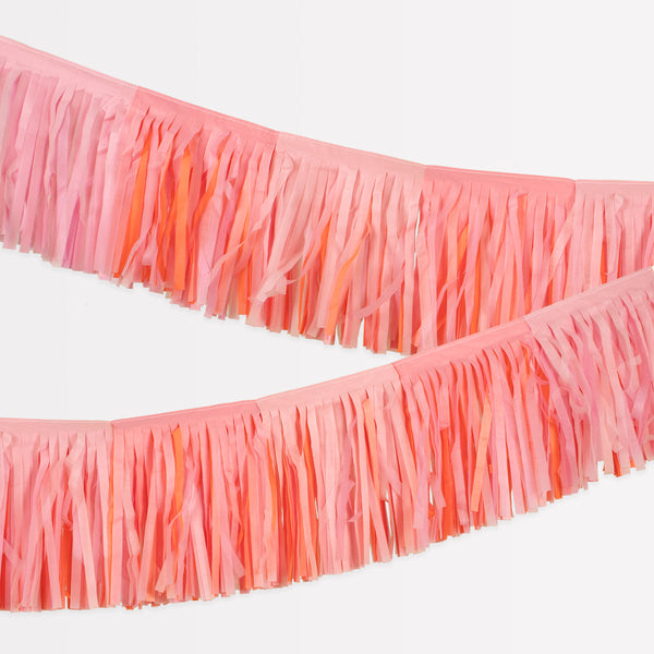 Our fringe garland, made of pink tissue paper, is ideal as a princess party decoration, or for baby showers, bridal showers or fairy parties.