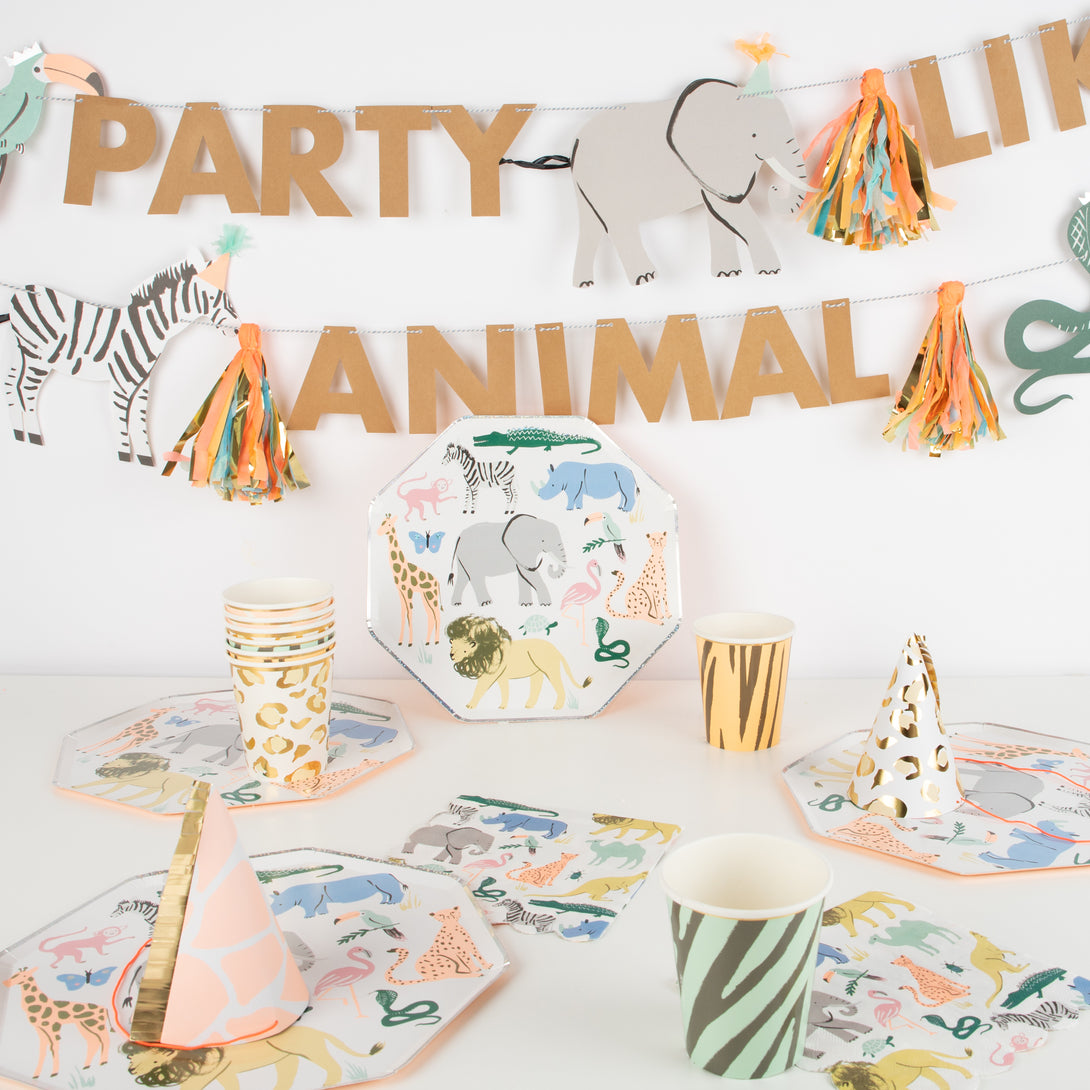 Our safari birthday party collection contains plates, party hats, cups. napkins and a party garland.