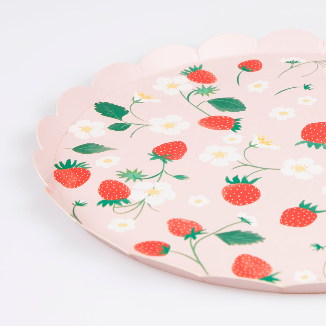 Our paper plates, in a small side plate size, feature a pretty pink and red strawberry design and scalloped edge.