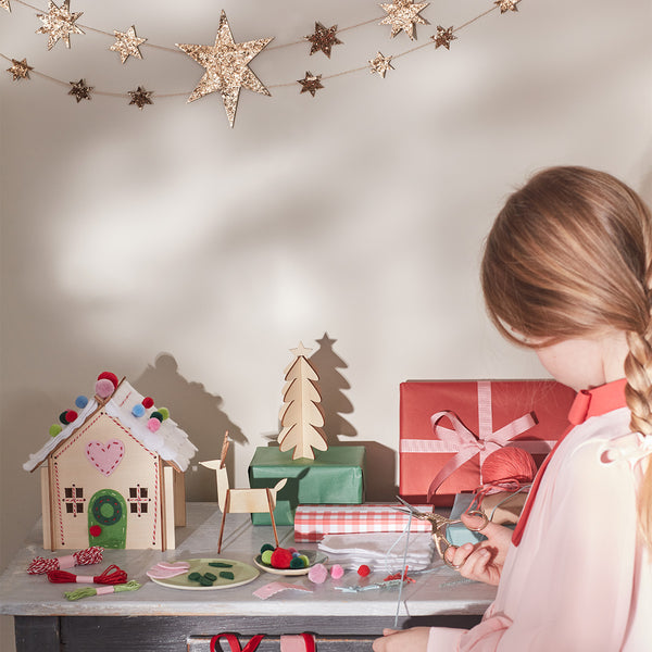 Our wooden gingerbread house features embroidery, felt and pompoms, with wooden reindeer. Perfect as a kids craft project. Image2