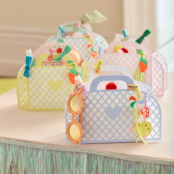 Our party favour bags are designed to look like little baskets, in pink, blue, mint and yellow, complete with paper charms tied on with ribbons. Image2
