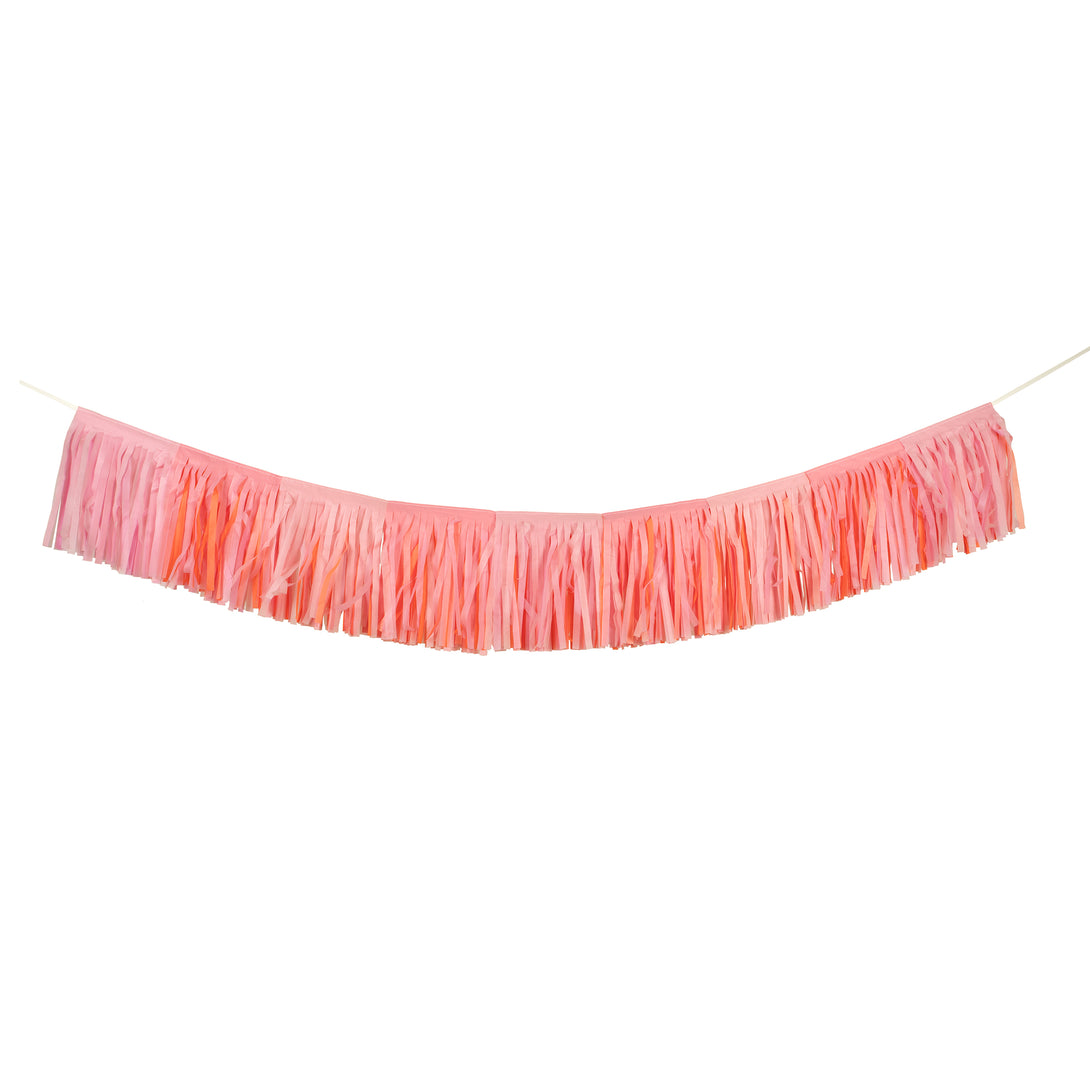 Our fringe garland, made of pink tissue paper, is ideal as a princess party decoration, or for baby showers, bridal showers or fairy parties.