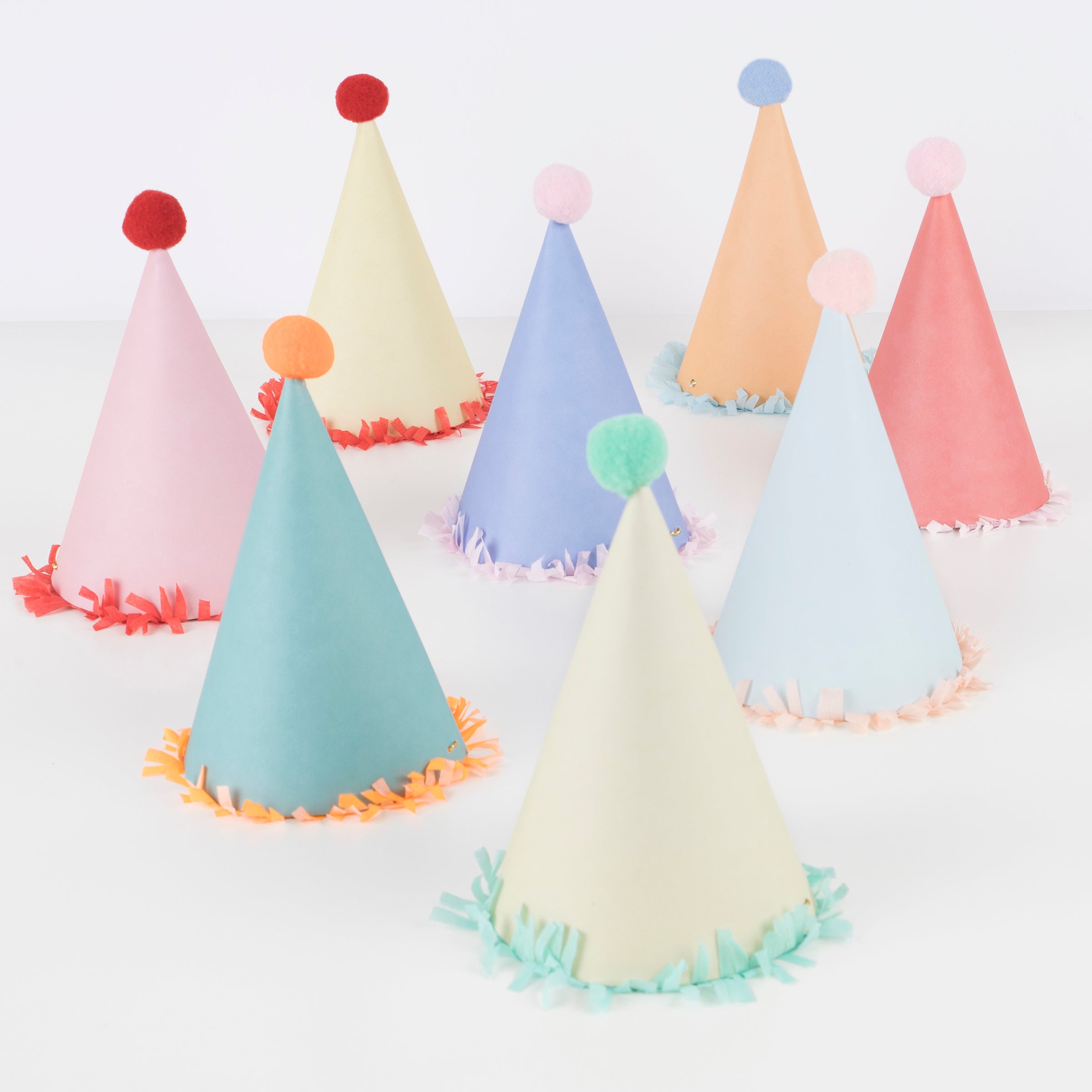 Our paper hats feature fringing, pompoms and bright colours.