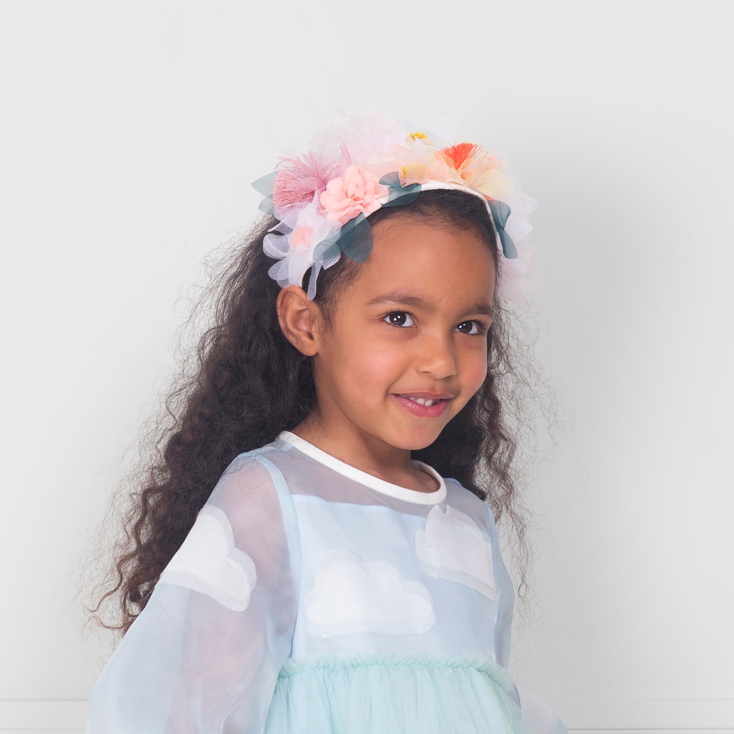 Our summery headband is embellished with organza flowers.