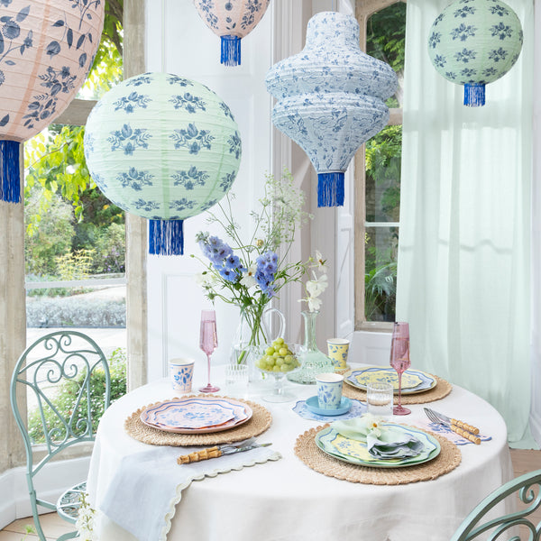 Our paper lanterns set, of three, come in mint, blue and pink, with round, wavy and oval shapes, with blue botanical illustrations and blue tassels. Image2