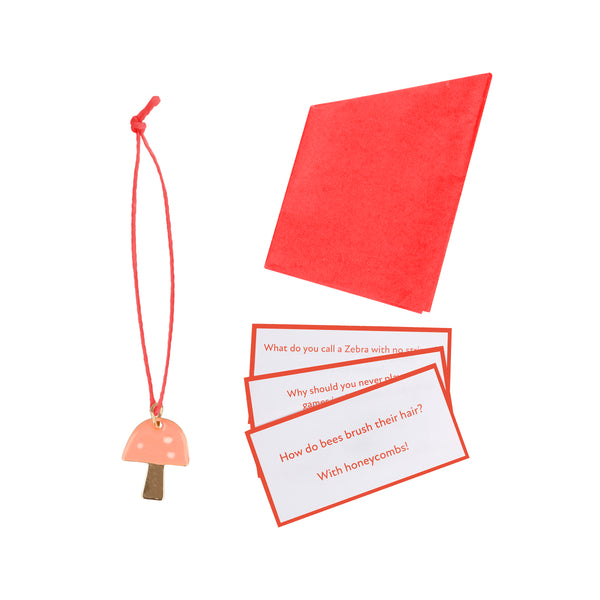 Our luxury Christmas crackers, in the shape of mushrooms, contain a red party hat, a joke and a fun enamel mushroom charm. Image2