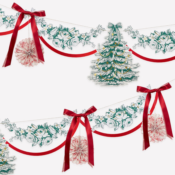 Our Christmas garland has paper foliage, pinwheels and a decorative tree, all with an elegant Toile de Jouy print, topped with ribbon bows. Image1