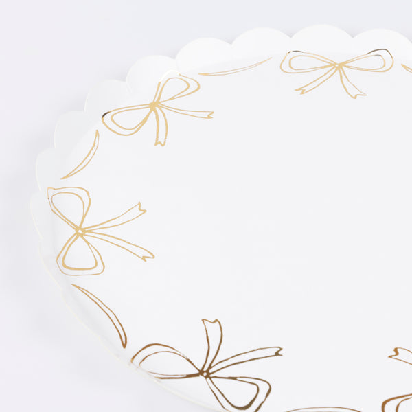 Add our stylish paper dinner plates to your Christmas party supplies, the gold bow design and scalloped border are so elegant. Image2
