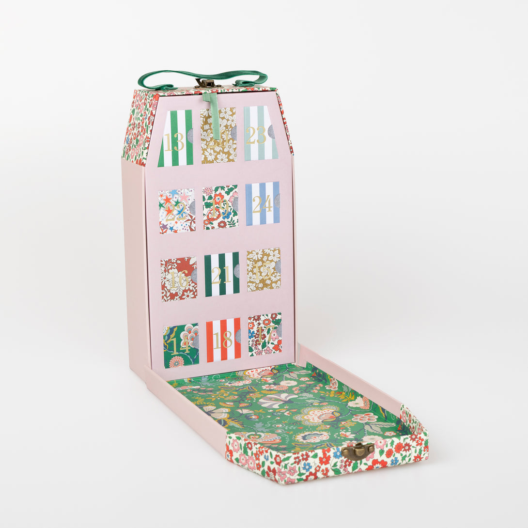 Our luxury advent calendar is designed as a suitcase-style box, with Liberty floral print details, inside which is a bracelet and charms Image3