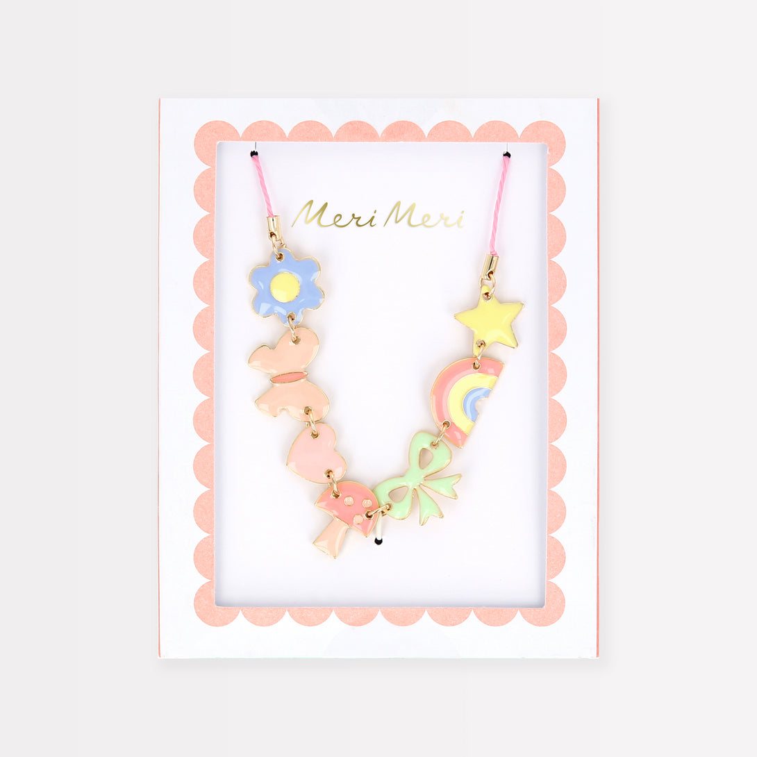 Our charms necklace is crafted with colourful enamel charms with a pink cord and gold tone lobster clasp, a pretty necklace for kids.