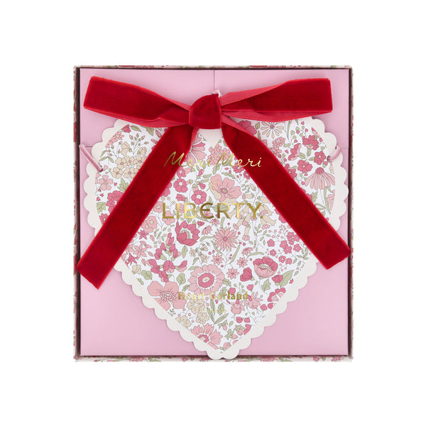 Our Valentine's Day garland feature paper hearts with floral Liberty print designs and pink and red luxe velvet bows. Image5