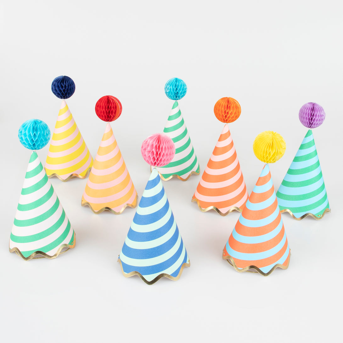 Our party accessories include hats with stripes and pompoms for a fun look.