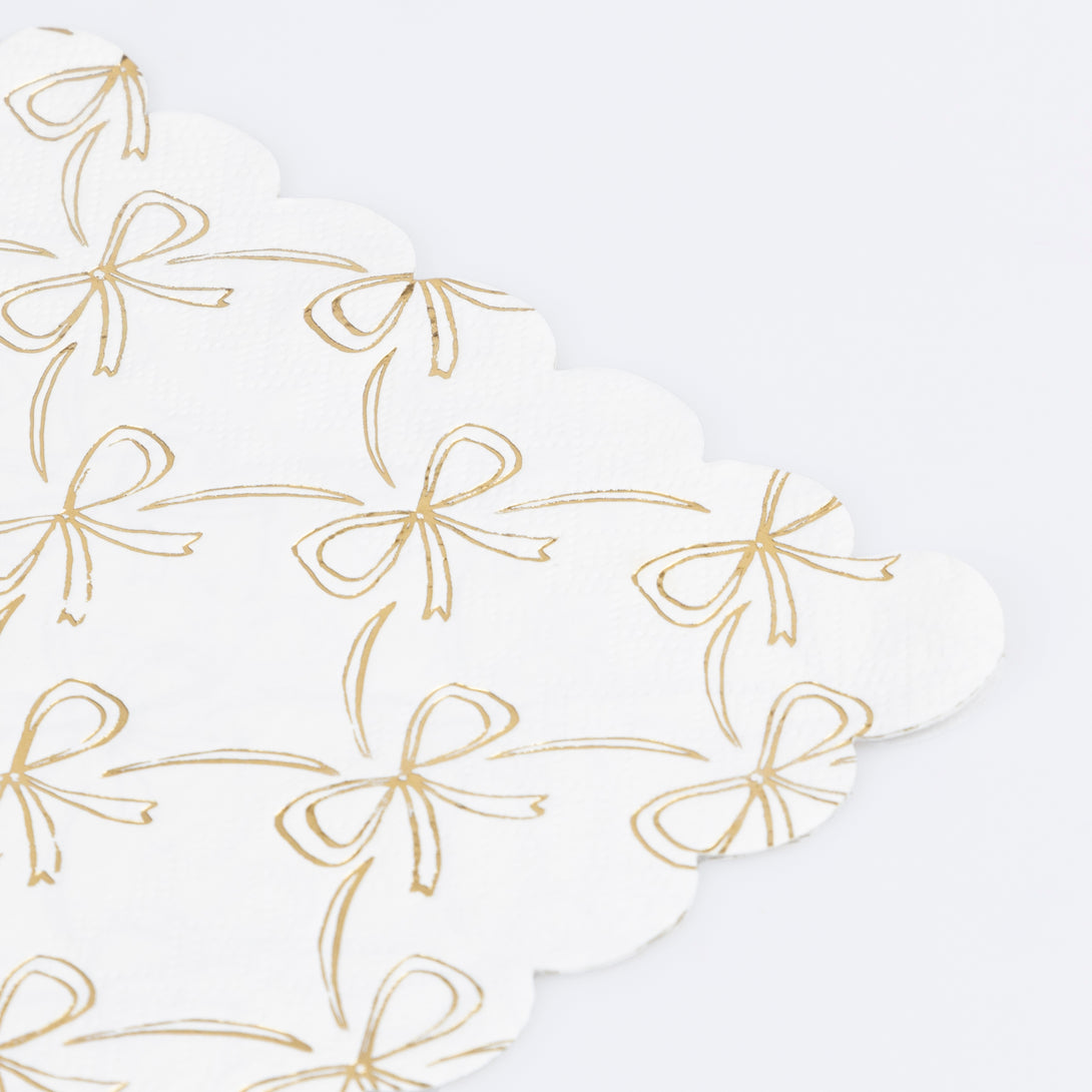 Our Christmas paper napkins have a shiny gold foil bow design to add sophistication to your festive parties. Image2