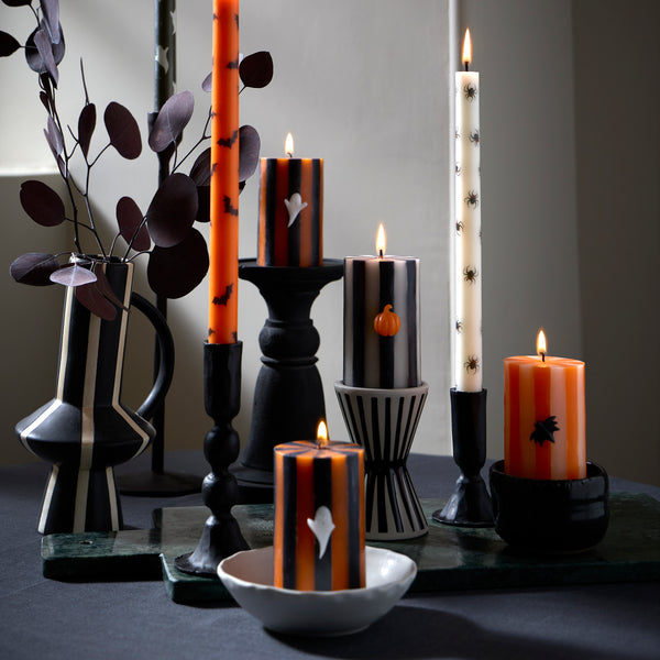 Our Halloween candles set of three features striped designs with classic icons of a ghost, bat and pumpkin for  magical decorative touch. Image2