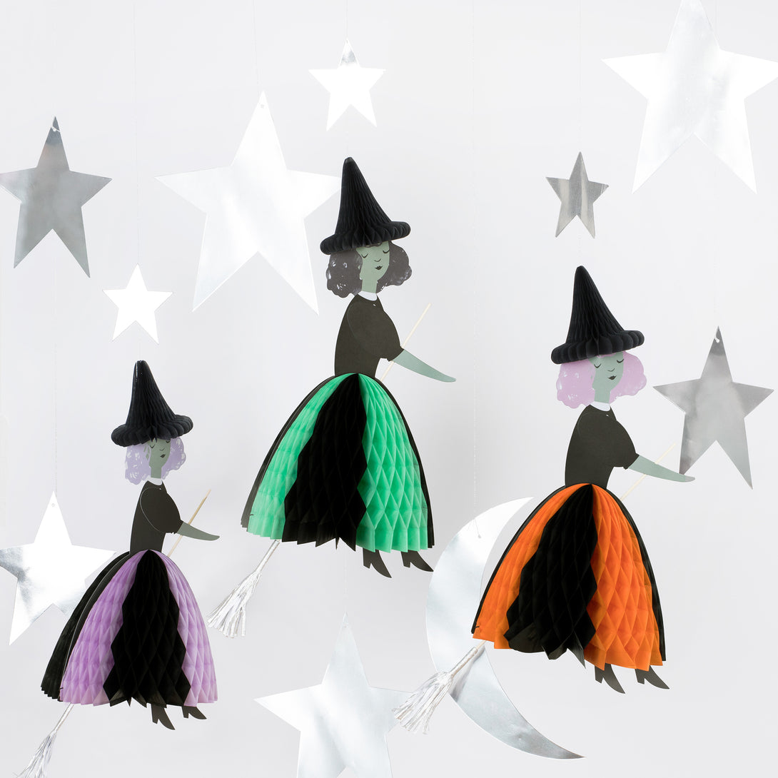 Our Halloween hanging decorations feature happy witches with honeycomb details, and shiny silver stars and a moon.