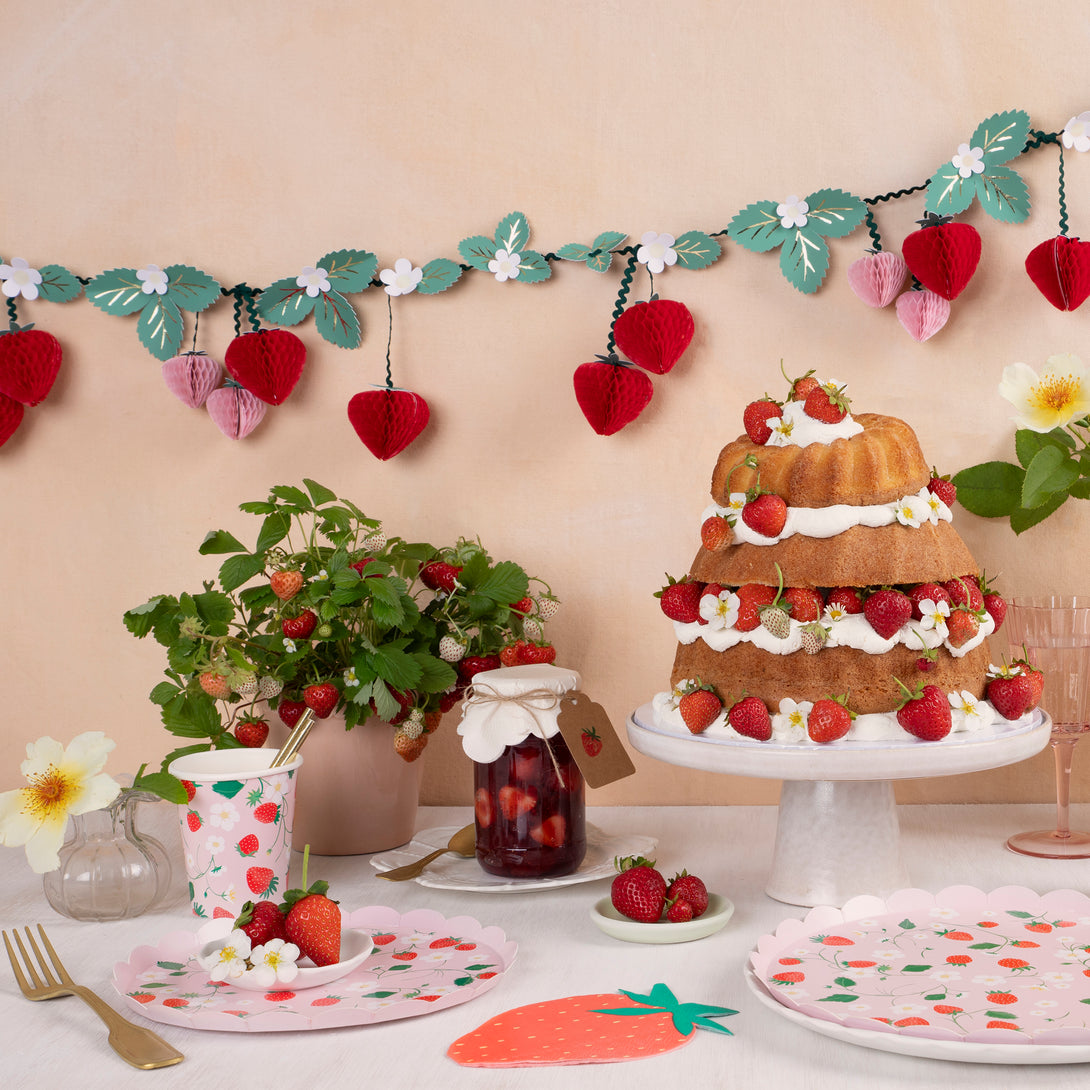 Our paper plates, in a small side plate size, feature a pretty pink and red strawberry design and scalloped edge.