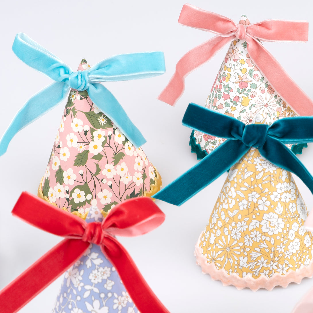 Our sophisticated paper hats, with Liberty floral print designs, velvet bows and velvet ricrac, are great as tea party hats.