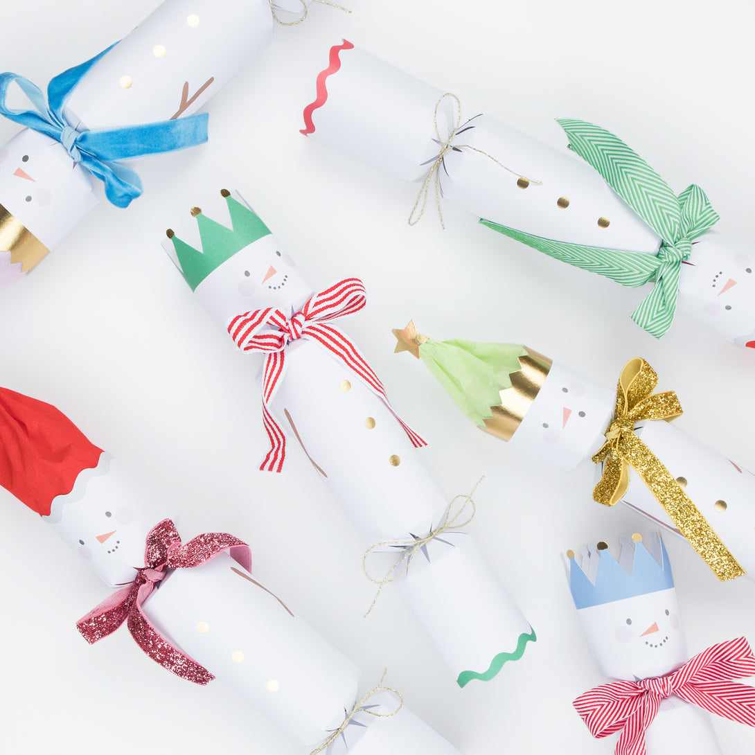 Our family crackers feature jolly snowmen with scarves and hat embellishments, and contain a joke, party hat and a fun eraser.