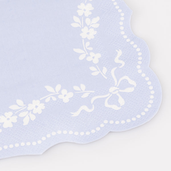 Our small paper napkins are made in cornflower blue with a white ornate design and sculptured edges, perfect for any sophisticated table setting. Image2