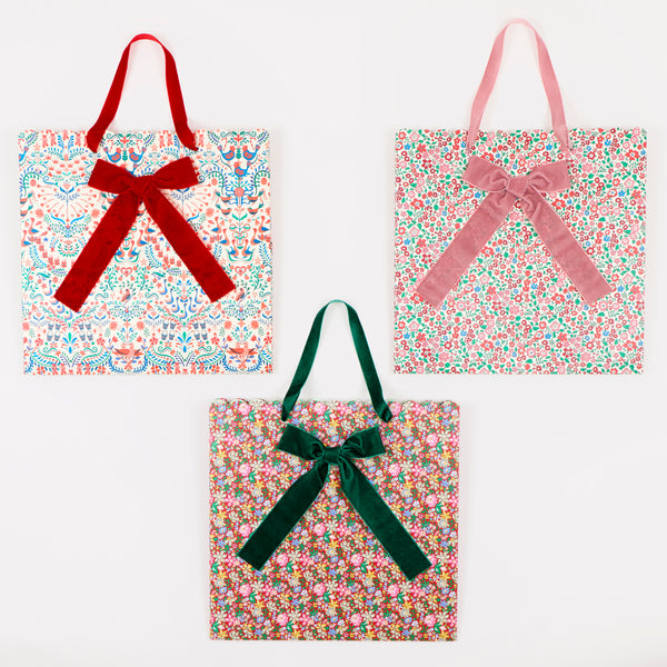 Our large paper Christmas gift bags feature Liberty print designs for an elegant look, with three designs, velvet ribbon bows and handles. Image3