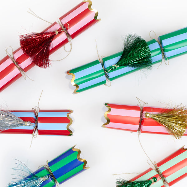 Our Christmas party crackers, with fun stripes and tinsel tassel details, contain a gold party hat, joke and a small gift to delight your guests. Image4