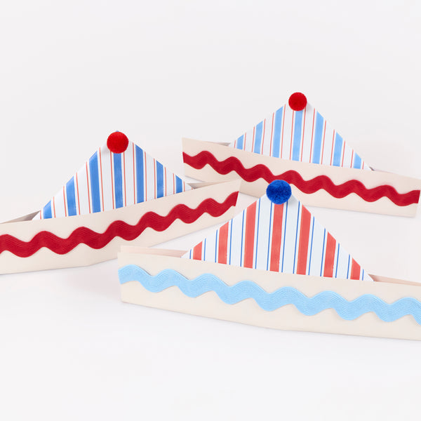 Our party hats are beautifully made from paper in the shape of sailor hats with stripe designs and embellished with ricrac and pompoms, Image1