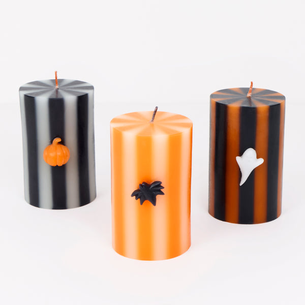 Our Halloween candles set of three features striped designs with classic icons of a ghost, bat and pumpkin for  magical decorative touch. Image1