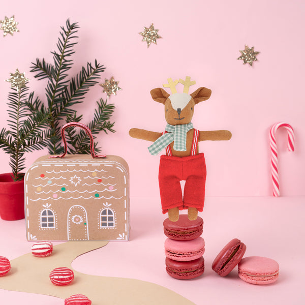 Our Christmas doll set includes a mini fabric reindeer doll in a laminated mini suitcase designed to look like a gingerbread house. Image2