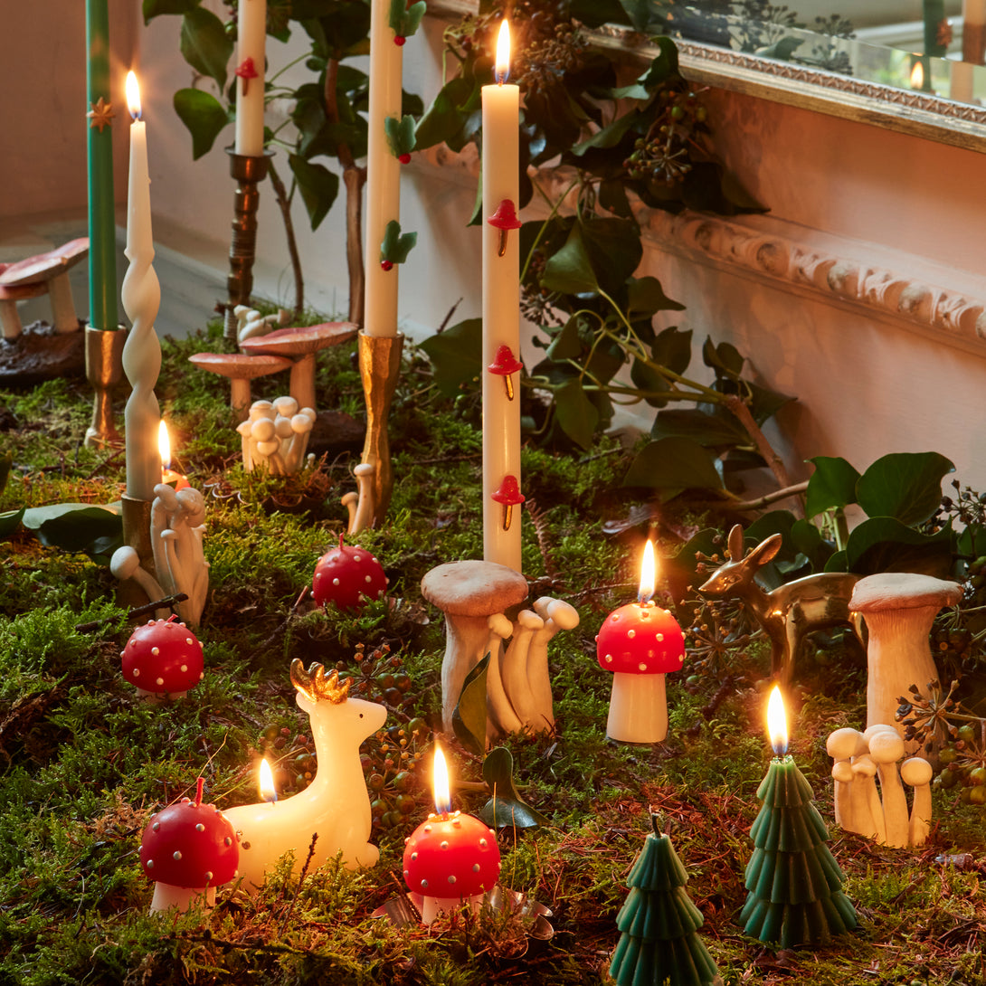 Our Christmas candles, are shaped like little mushrooms, in red and white with red wicks.