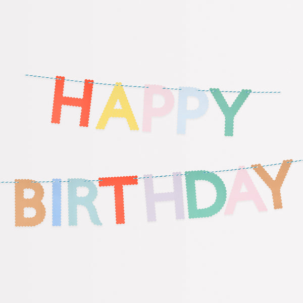 Our Happy Birthday garland, made with bright paper letters with scalloped details, adds a stylish and colourful decoration.