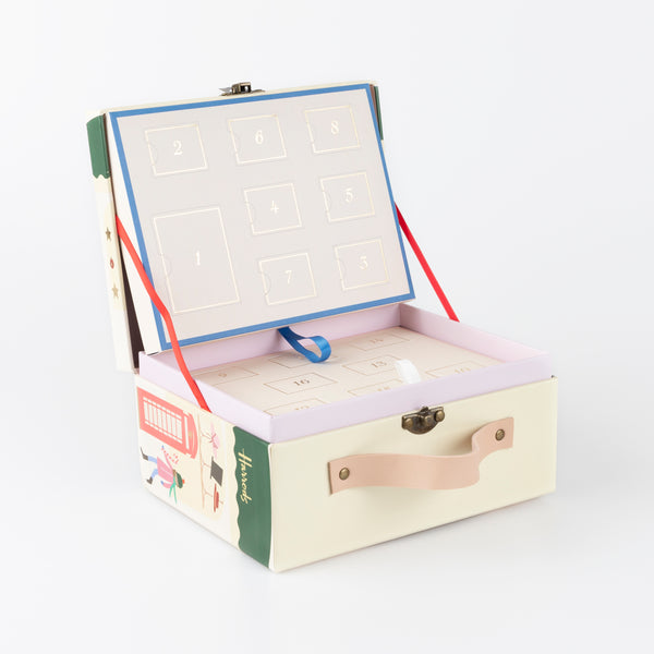 Our iconic Harrods mini suitcase includes an advent calendar where you'll get to create a charm bracelet over 24 days. Image5