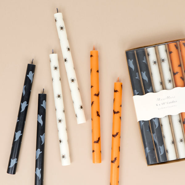 Our tall Halloween candles, in orange, black and white, feature ghosts, bats and spiders, and coloured wicks. Ideal for party decorations. Image1