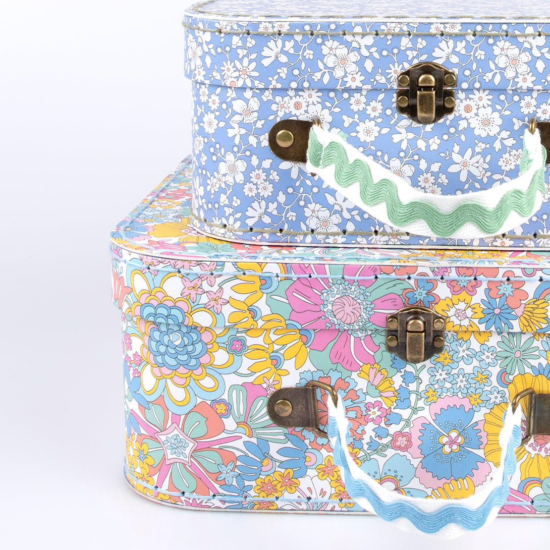 Our mini suitcases feature Liberty floral print designs and stitched card, so are sophisticated travel accessories and storage solutions.