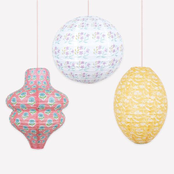 Our paper lanterns, a set of three with pink and yellow floral print designs, feature a round, oval and wavy shape, great for chic parties. Image1