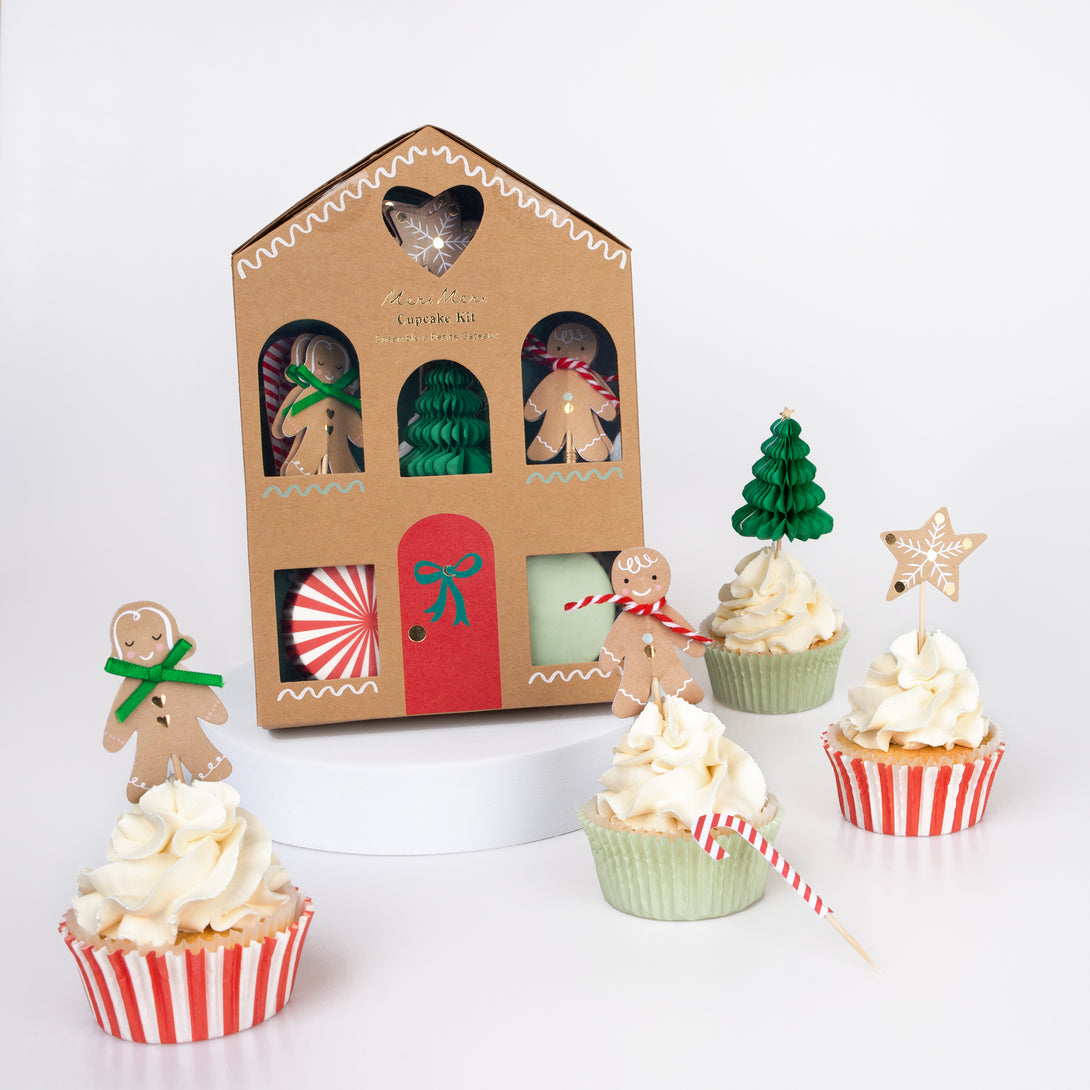 Our special Christmas cupcake kit features festive cupcake toppers and cupcake cases all packaged in a charming paper gingerbread house.