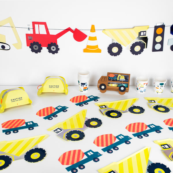 Our construction party supplies include paper plates, a 3D garland, cups, napkins, hats and a cupcake kit. 