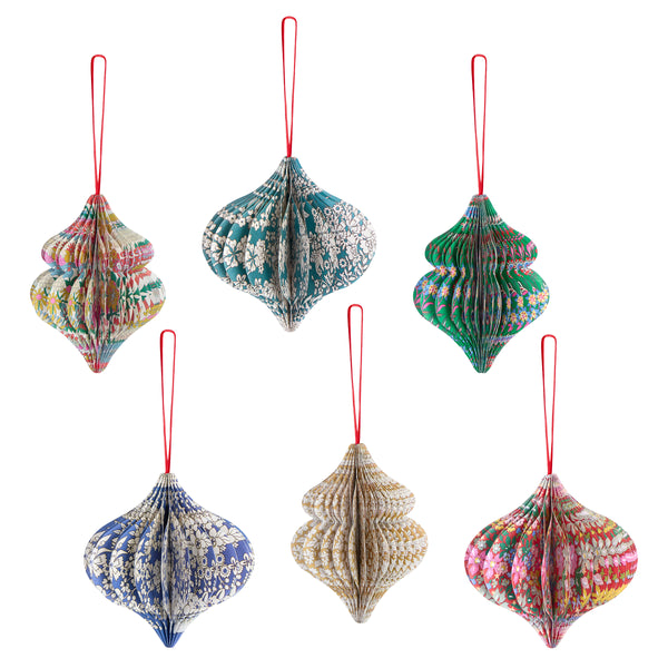 Our Christmas tree decorations, in elegant ornamental shapes, have honeycomb details and beautiful Liberty print designs in festive colours. Image1