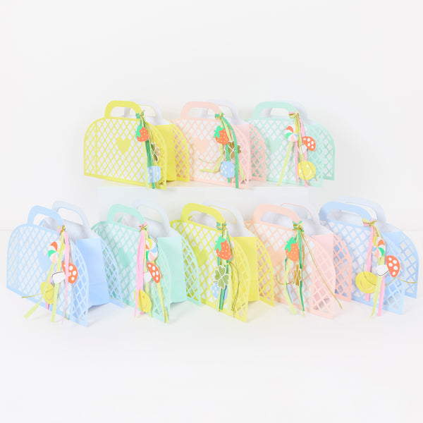 Our party favour bags are designed to look like little baskets, in pink, blue, mint and yellow, complete with paper charms tied on with ribbons. Image1