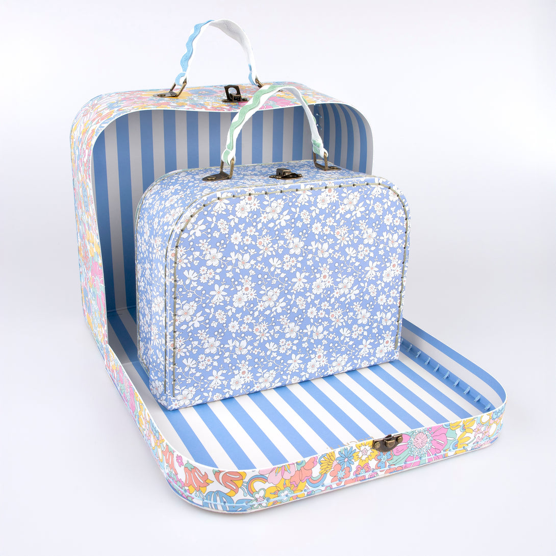 Our mini suitcases feature Liberty floral print designs and stitched card, so are sophisticated travel accessories and storage solutions.