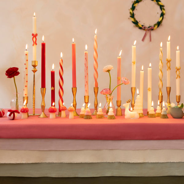 Use our Christmas table candles, with festive patterns and colours, to light up your dinner table or mantel. Image2