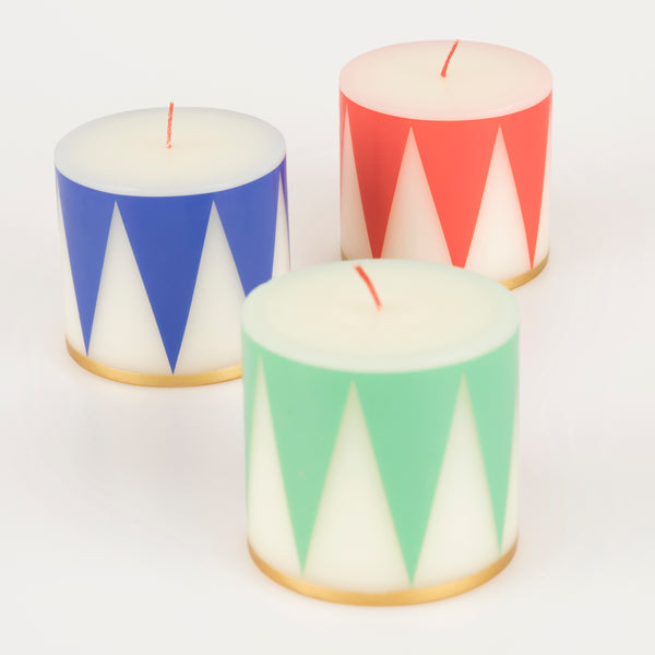 Our Christmas candle set of 3 candles have traditional Nutcracker designs of red, green and blue, with gold details and red wicks. Image3