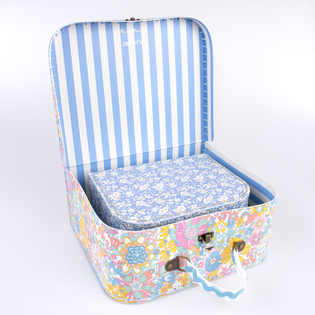 Our mini suitcases feature Liberty floral print designs and stitched card, so are sophisticated travel accessories and storage solutions.