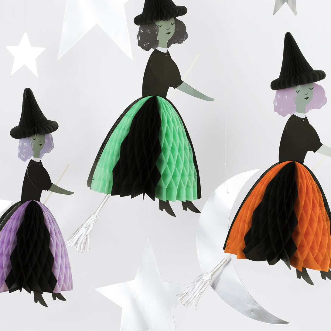 Our Halloween hanging decorations feature happy witches with honeycomb details, and shiny silver stars and a moon.