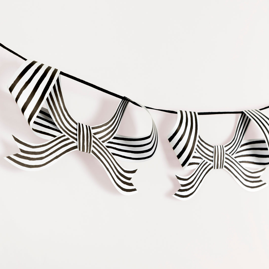 Our paper garland is perfect to add to your Halloween hanging decorations, with black and striped bows it's eerily stylish. Image3