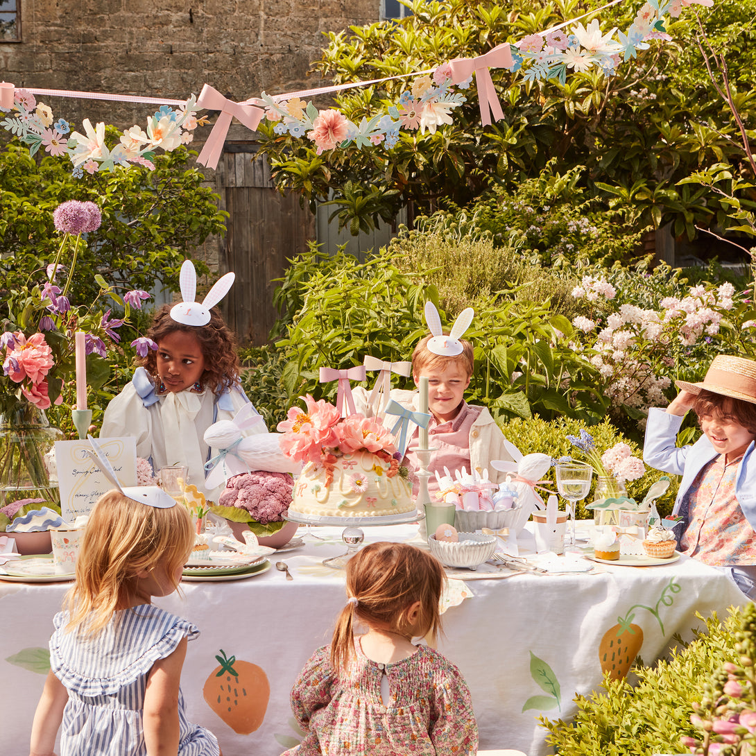 Our paper garland, featuring flowers and bows, is the perfect baby shower garland or Easter garland.